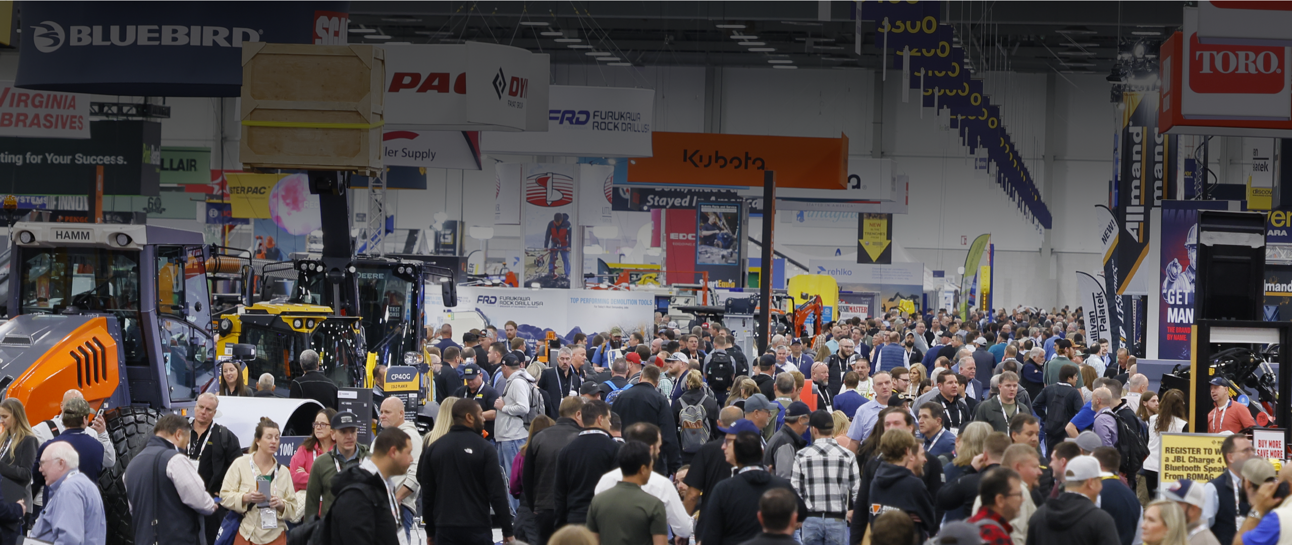 A crowd moves through the busy indoor ARA Show 2026 with booths and displays for construction brands, highlighting fleet management.