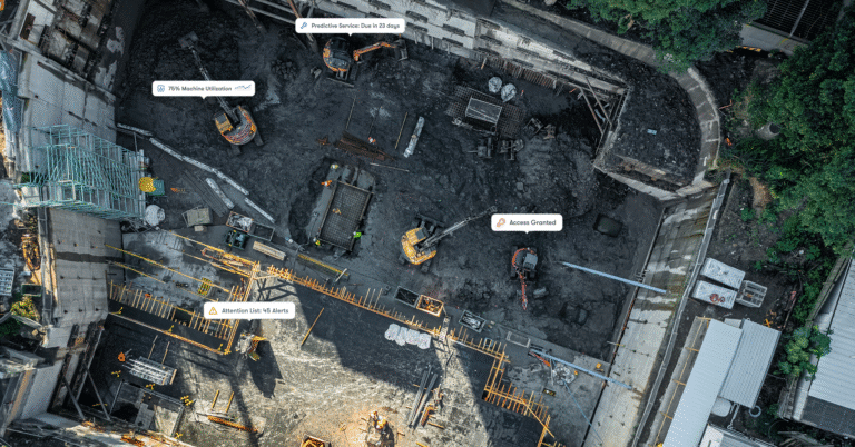 Aerial view of a construction site with excavators, machinery, labeled tags, and workers—an example of a connected jobsite.