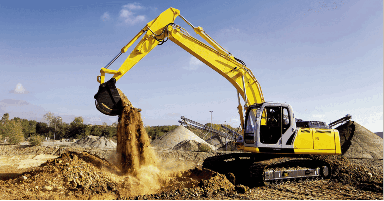 A yellow excavator with aftermarket parts moves dirt at a construction site, surrounded by equipment and earth under a blue sky.