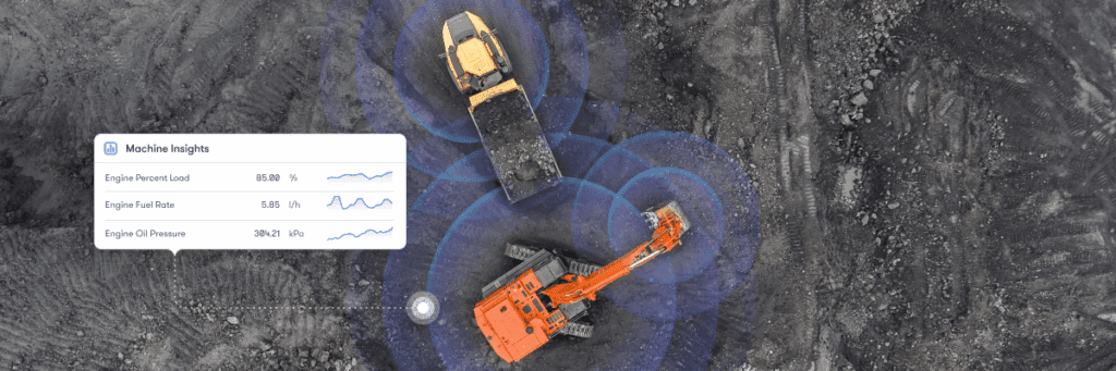 Aerial view of two construction vehicles on a dirt site with blue signal rings and a machine insights overlay for construction IoT.