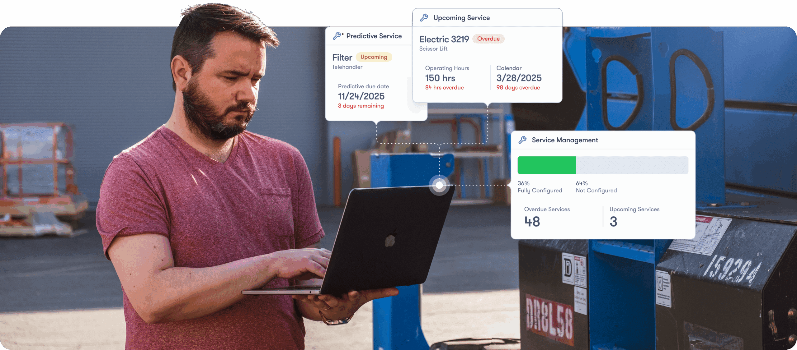 A man in a red t-shirt uses a laptop near industrial equipment, viewing digital maintenance data for construction equipment tracking.