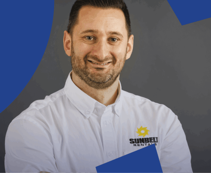 A man in a white Sunbelt Rentals shirt smiles at the camera, with a gray background and blue shapes, suggesting fleet management.