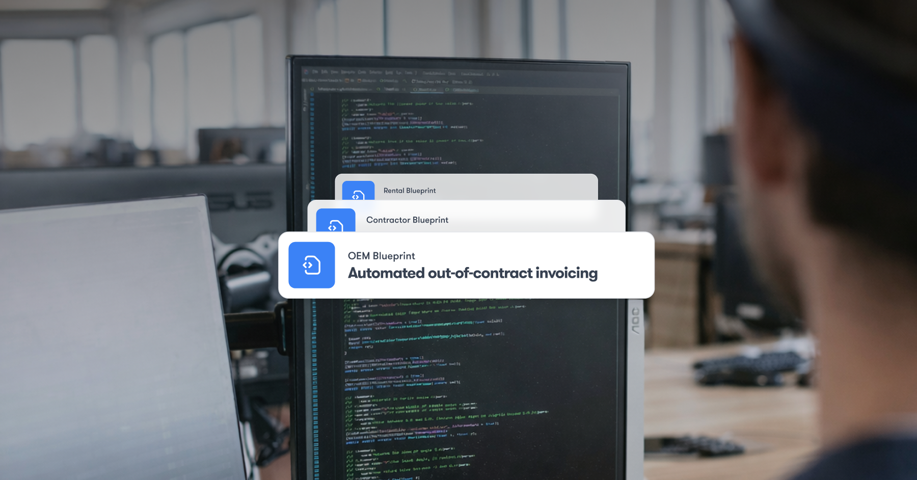 A person at a desk with code on screens, digital cards showing invoicing blueprints for fleet management on the IrisX platform.
