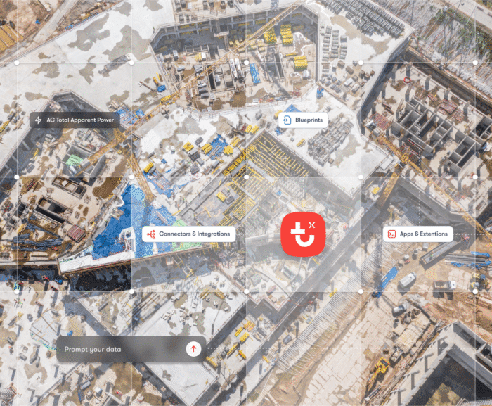Aerial view of a busy construction site with icons and labels showing interconnected workflow features on a connected jobsite.