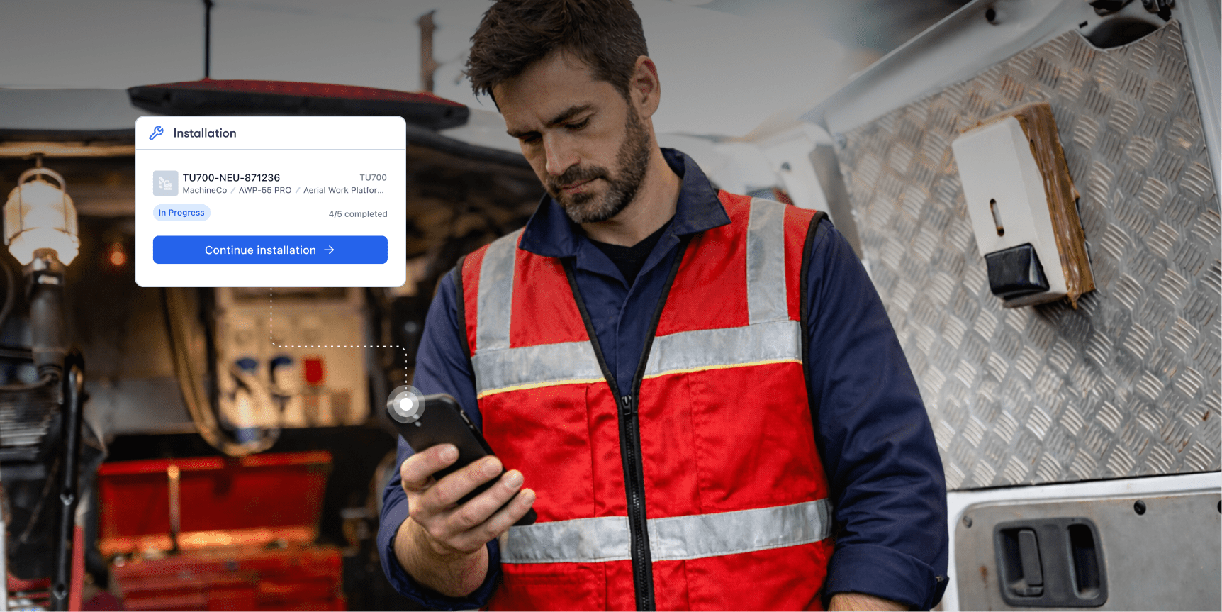 A man in a red safety vest stands by a work van, checking his phone, with an install progress graphic for fleet management.