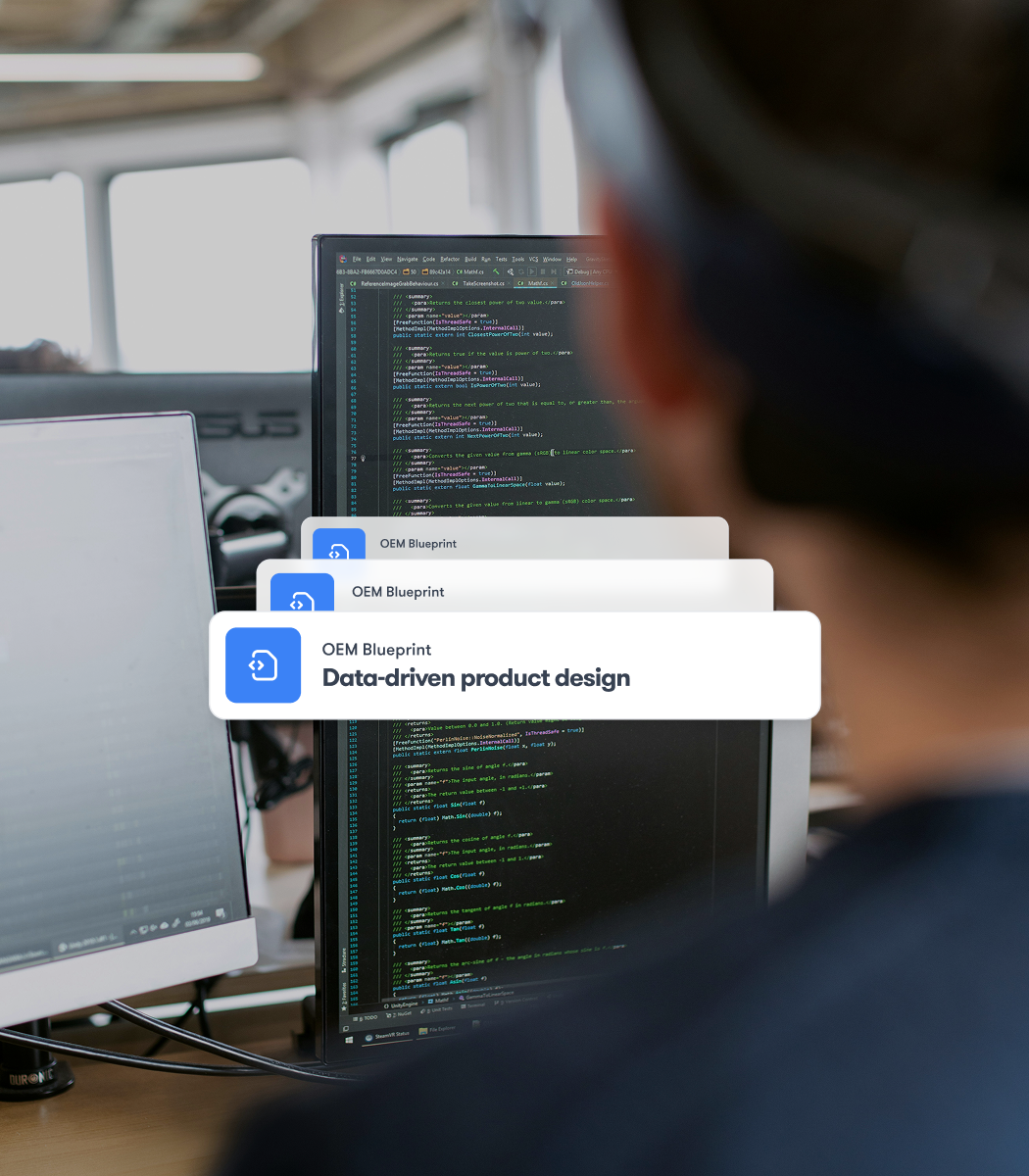 A person works at a desk with dual monitors showing code, with overlays highlighting data-driven product design for construction IoT.