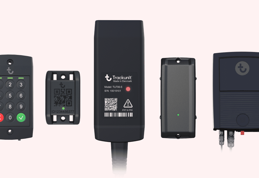 Five black electronic devices for construction equipment tracking, including a keypad, QR code tag, and central unit with indicator light.