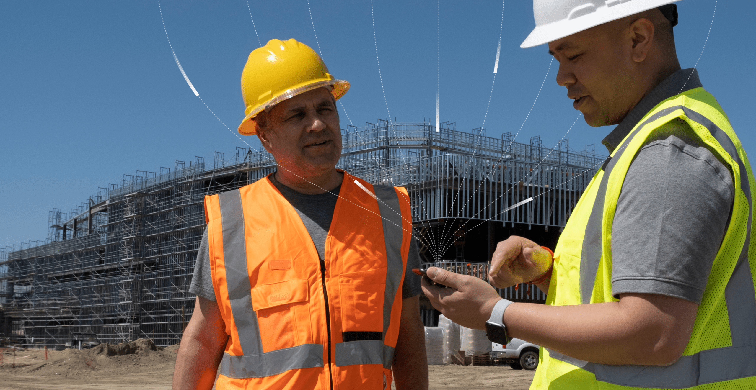 Two construction workers with a tablet at a jobsite, digital lines highlight connected jobsite technology in the background.