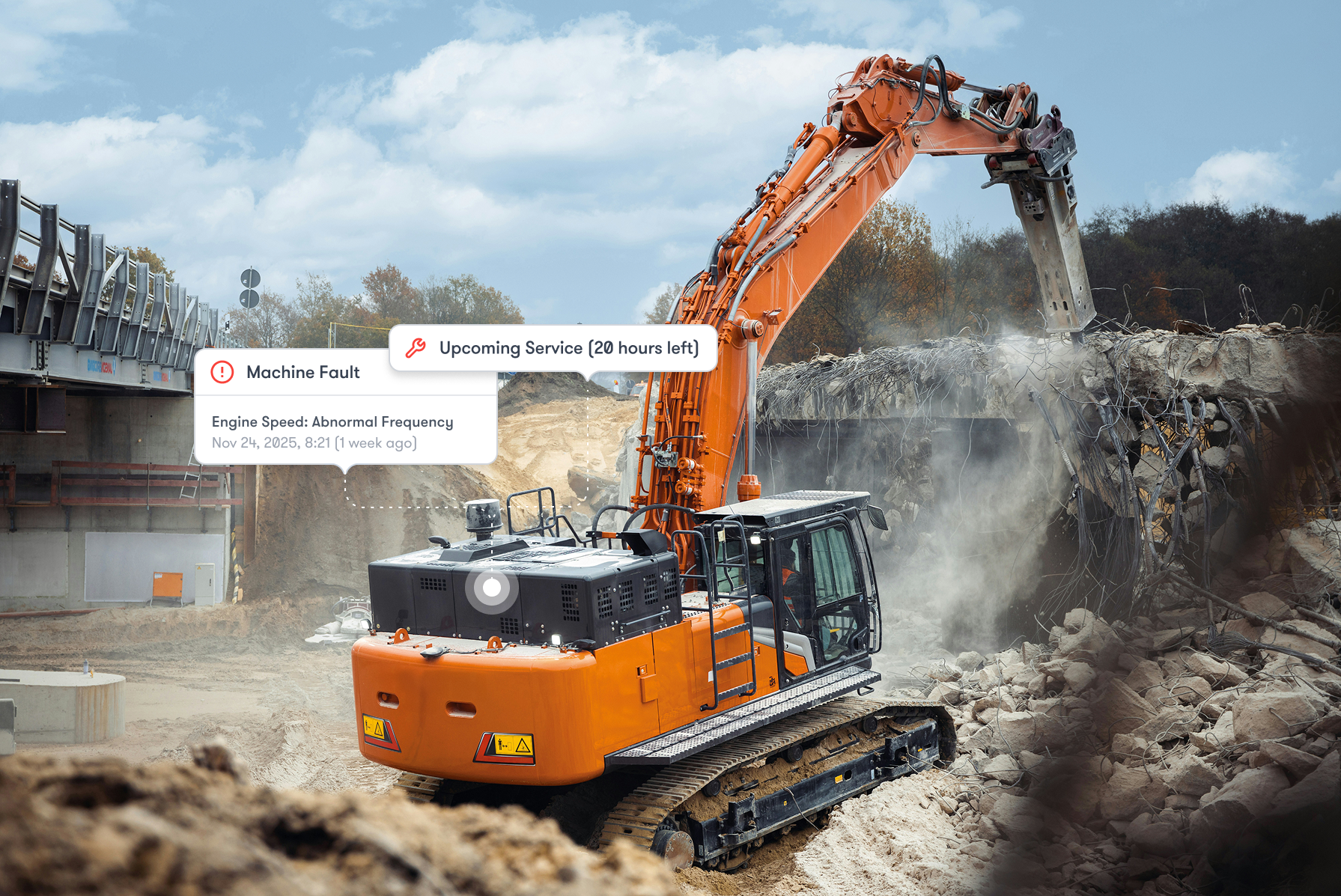 An orange excavator demolishes concrete as AI overlays display machine fault alerts and a service reminder, highlighting connected jobsite.