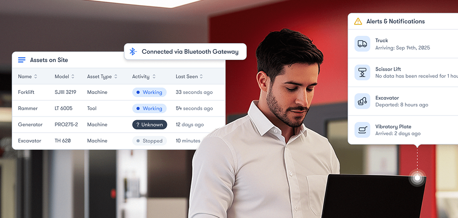 A man uses a laptop indoors with on-screen rental fleet data, asset tracking, and alerts for connected jobsite management.