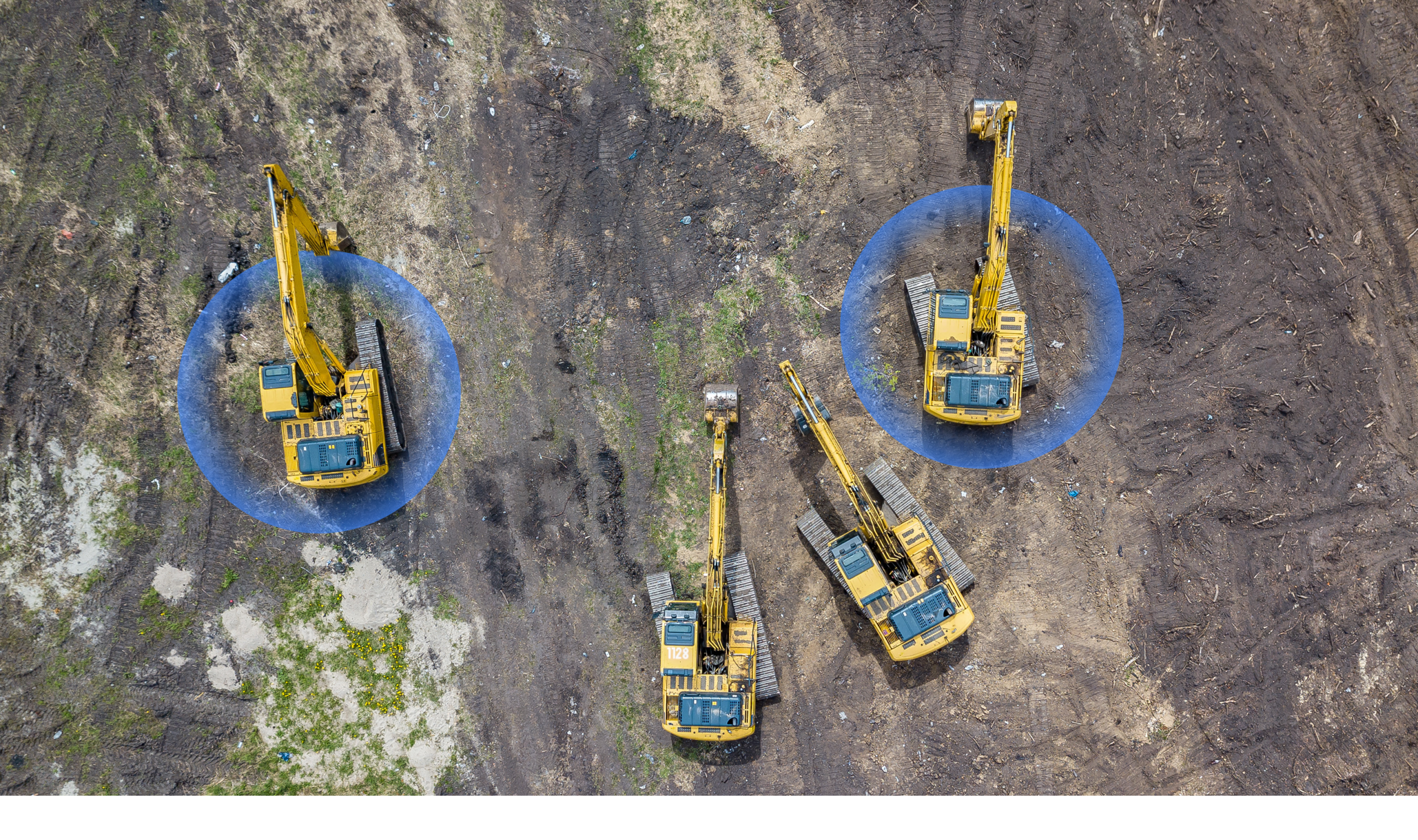 Aerial view of four yellow excavators on a construction site with two highlighted, illustrating equipment tracking for fleet management.