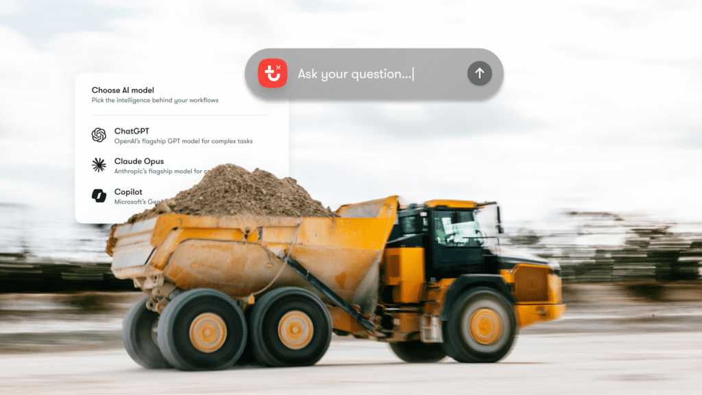 A yellow dump truck with a digital overlay showing AI models and a search bar, illustrating construction equipment tracking.