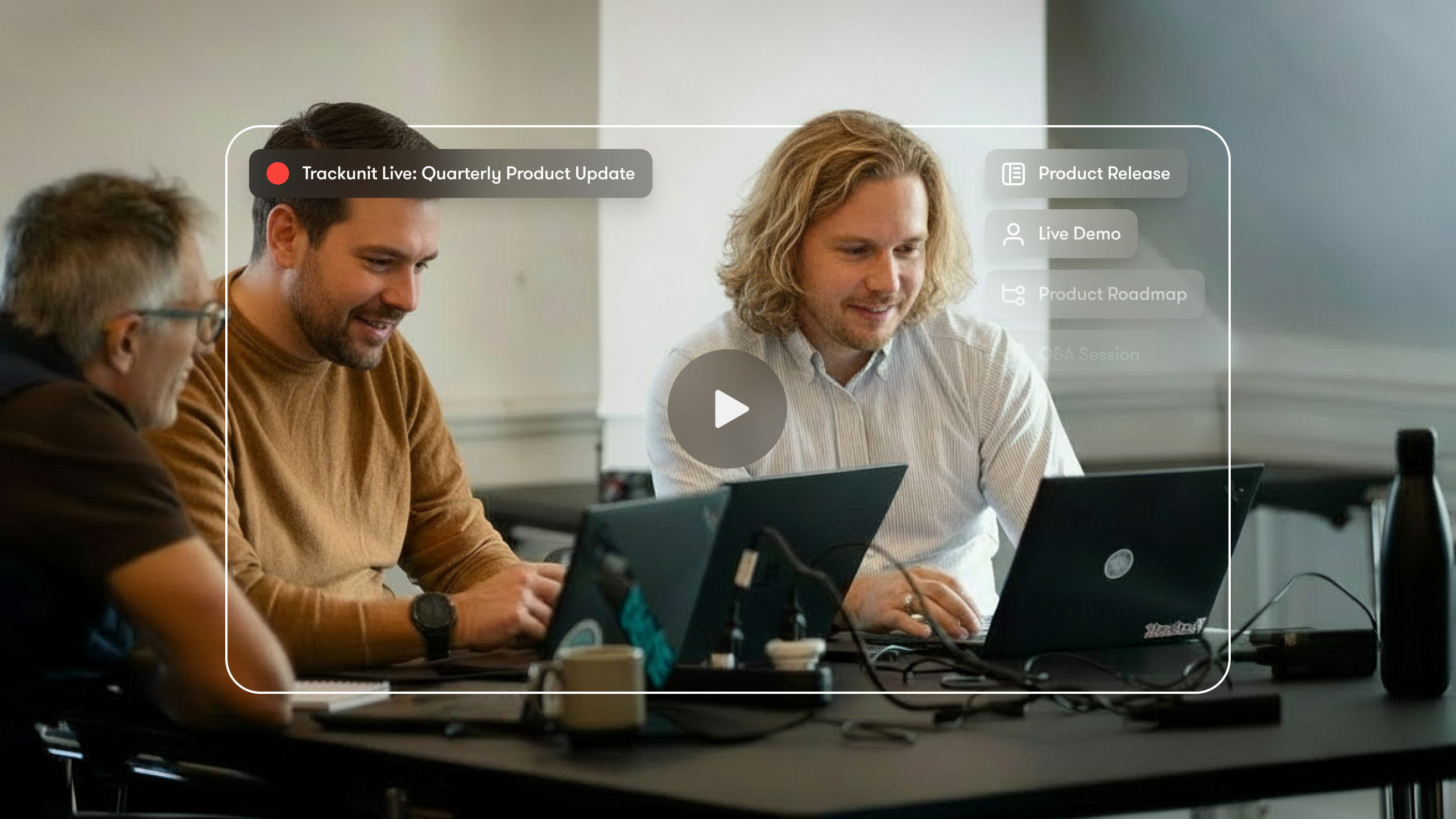 Three people work together on laptops with a paused Trackunit Live webinar about product updates, related to construction IoT.
