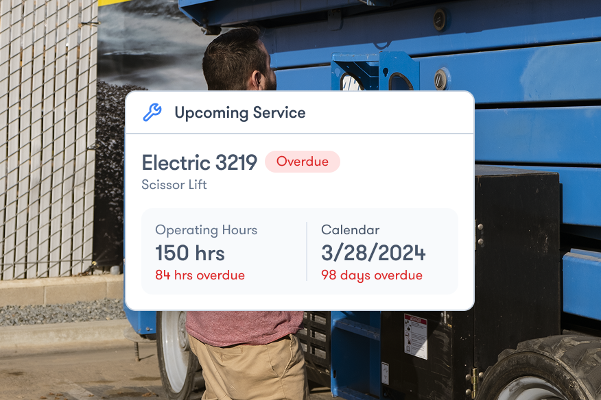 A man stands by a blue scissor lift. An overlay shows overdue service for Electric 3219, aiding construction equipment tracking.