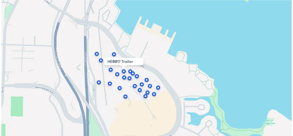 Map view of a construction jobsite showing blue location pins for unpowered construction equipment tracking, including one labeled HE0017 Trailer.