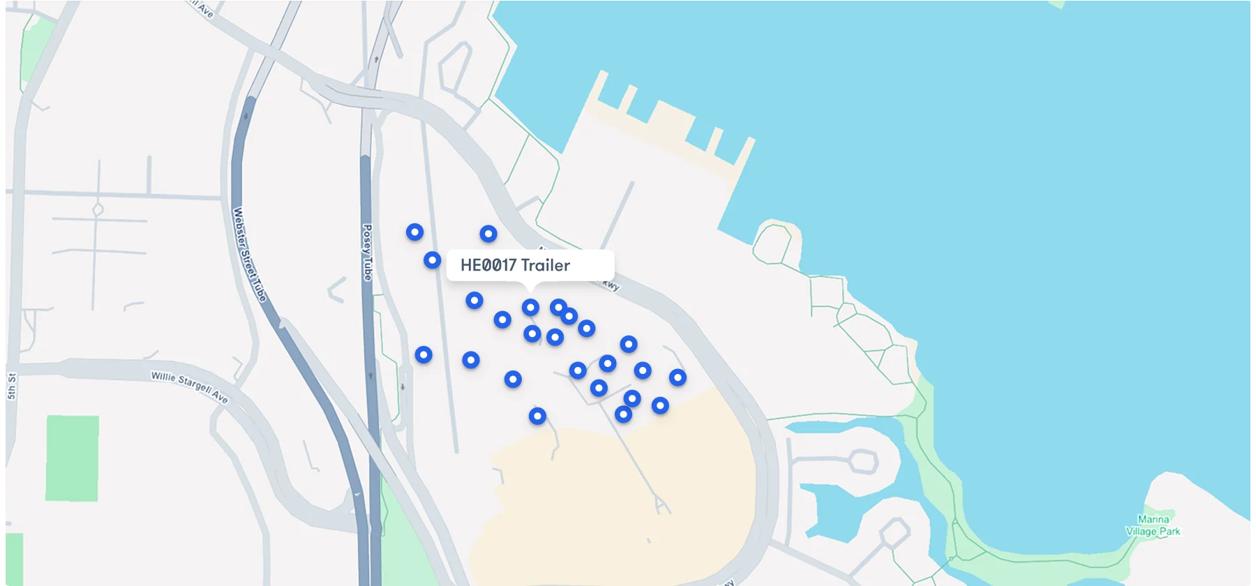 Map view of a construction jobsite showing blue location pins for unpowered construction equipment tracking, including one labeled HE0017 Trailer.