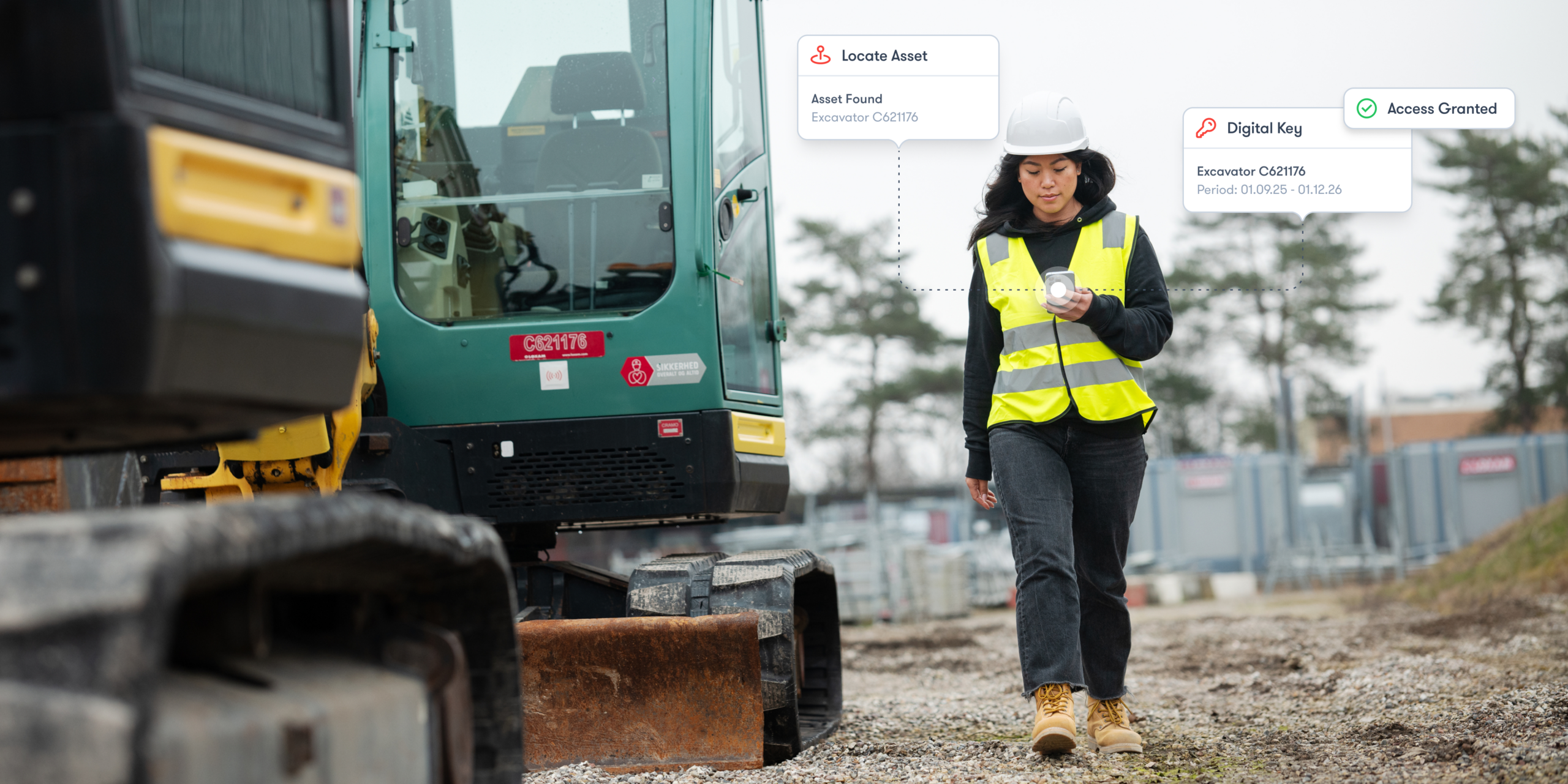 A woman in a hard hat and safety vest holds a smartphone at a construction site, walking beside MCP construction rental machinery as digital notifications about asset location and access appear, illustrating construction equipment tracking.