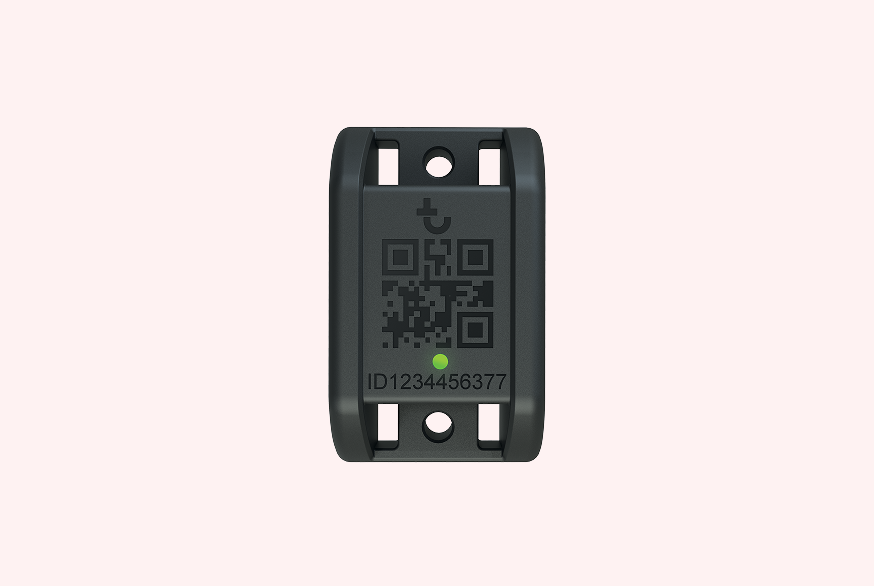 Small black construction equipment tracking device with a QR code, status light, and ID number 1234456377.