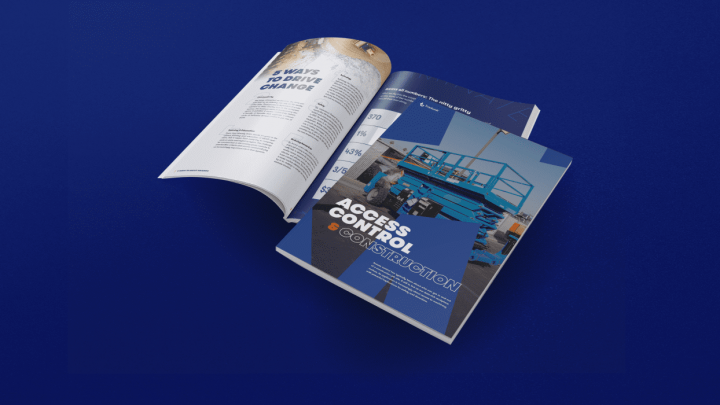 Two open magazines on a blue surface; one covers access control construction, the other highlights innovative connected jobsite ideas.