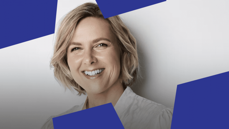 A smiling person with short blonde hair in a white shirt, set against blue shapes, suggesting a positive construction IoT environment.