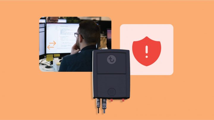 A man at a computer receives issue alerts, with a red shield icon and an electronic device nearby, illustrating construction IoT.