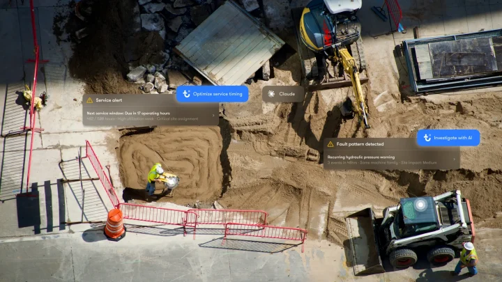 Aerial view of a construction site with workers, an excavator, and a skid steer loader, featuring digital interface overlays that use telematics to track equipment.