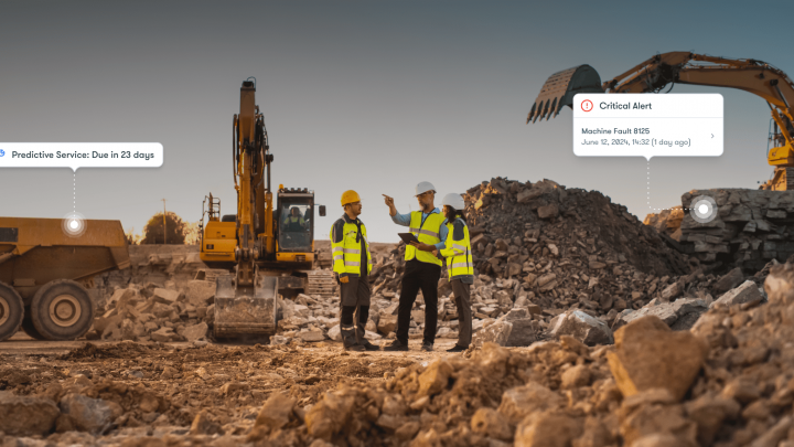 Three construction workers on a rubble site with excavators and telematics alerts, highlighting connected jobsite technology.