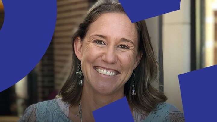 A woman with shoulder-length brown hair smiles at the camera, blue shapes overlaying the image, hinting at a connected jobsite.