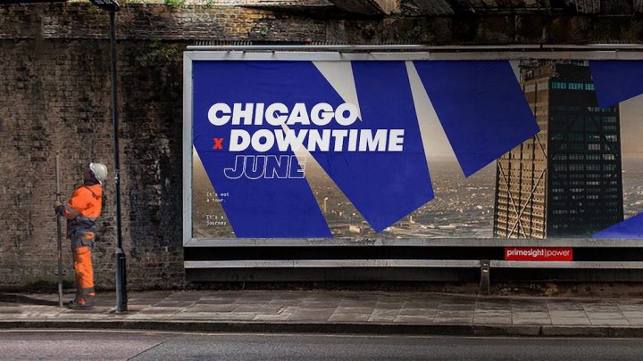 A construction worker in orange gear stands by a city billboard, highlighting change and connected jobsite themes.