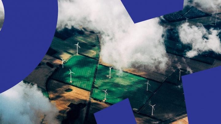 Aerial view of fields with wind turbines and blue geometric shapes, partially covered by clouds, suggesting connected jobsite.