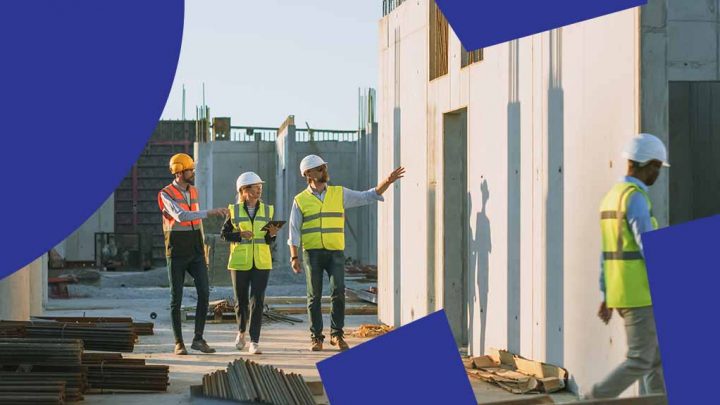 Three construction workers in safety vests and helmets walk through a jobsite, discussing progress, with blue graphic shapes overlayed. Connected jobsite.