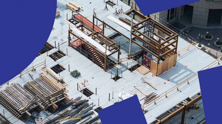 Aerial view of a construction site with metal beams on concrete, blue graphic shapes, highlighting construction IoT benefits.