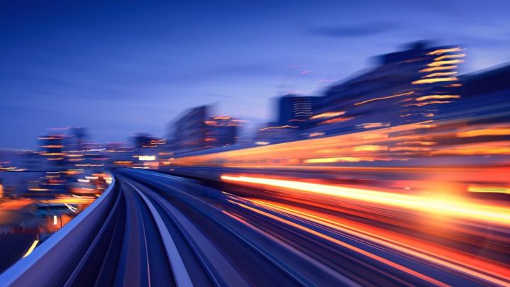 Blurred cityscape at night with bright light streaks, evoking motion and energy—ideal for illustrating connected jobsite concepts.