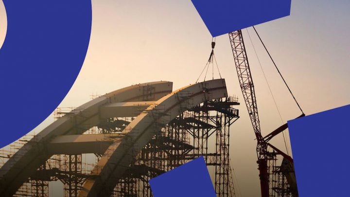 A crane lifts a curved structure at sunset on a scaffolded site, with blue digital shapes hinting at a connected jobsite.