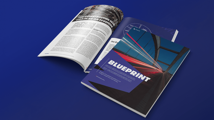 Two magazines on a blue surface, one closed with "BLUEPRINT For a Digital Era of Construction" cover—focus on connected jobsite.