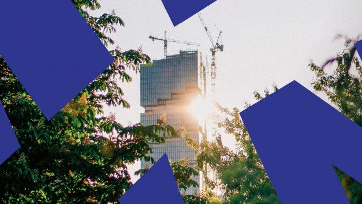 A modern skyscraper under construction with cranes and leafy trees, sunlight shining through, blue shapes overlayed—connected jobsite.