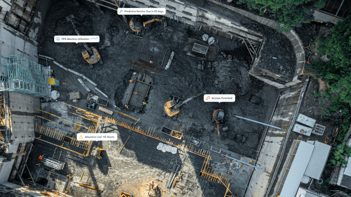 Aerial view of a construction site with excavators, machinery, labeled tags, and workers—an example of a connected jobsite.