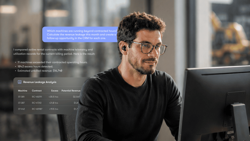 A man with glasses and earbuds works at a desk with a monitor, viewing a digital overlay showing data analysis on MCP construction equipment tracking, including usage and revenue leakage.