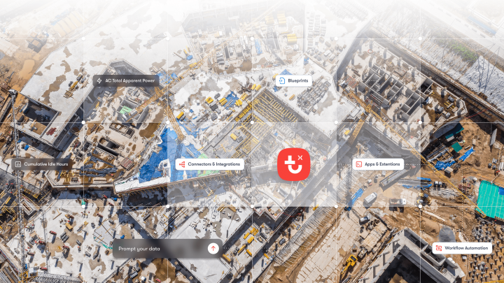 Aerial view of a snowy construction site with digital interface icons for blueprints and workflow, highlighting connected jobsite.
