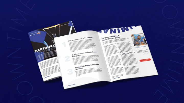 A booklet titled ELECTRIFICATION UNLOCKS OPPORTUNITY lies partially open on a blue surface, featuring content on fleet management.