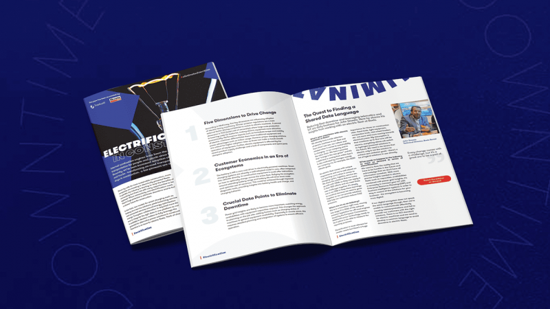 A booklet titled ELECTRIFICATION UNLOCKS OPPORTUNITY lies partially open on a blue surface, featuring content on fleet management.
