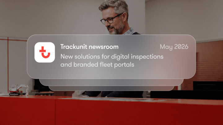 A man with gray hair and glasses stands behind a red counter. Overlay: Trackunit newsroom, May 2026—digital fleet management updates.