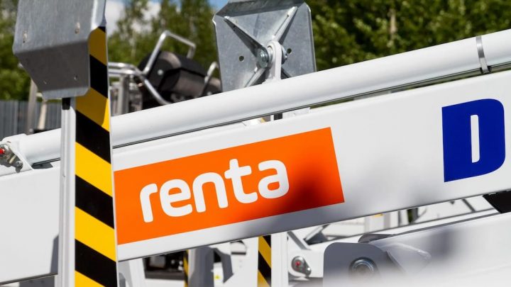 Close-up of digital construction equipment with an orange "renta" sign, yellow-black safety stripes, and fleet management context.