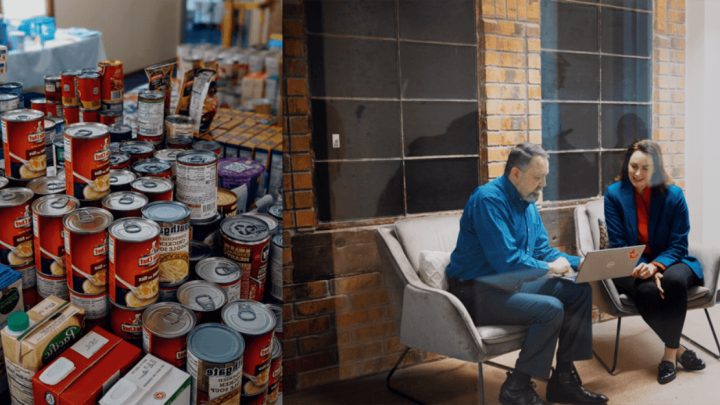Table with canned goods on the left; two people in an office discuss something on a Trackunit-enabled laptop, showing telematics use.