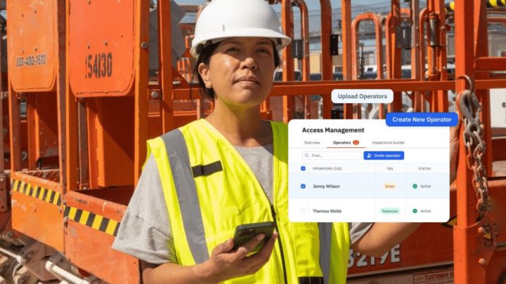 A construction worker at a job site checks a smartphone showing Trackunit's real-time access management for a connected jobsite.