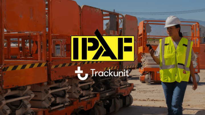 A woman in a hard hat and hi-vis vest inspects orange construction equipment outside, with Trackunit and IPAF logos shown centrally.