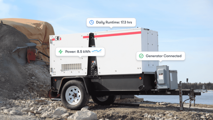 Trackunit portable generator on rocky ground at a construction site, showing usage stats; materials and water behind. Construction IoT.