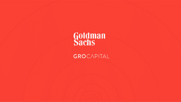 Goldman Sachs and GRO Capital logos centered on a red background with subtle circular patterns, referencing an acquisition.